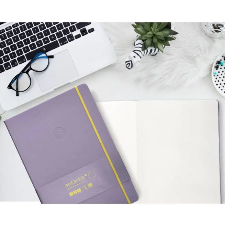CUADERNO CON GOMILLA ANTARTIK NOTES TAPA DURA A4 HOJAS LISAS MORADO Y AMARILLO 100 HOJAS 80 GR FSC